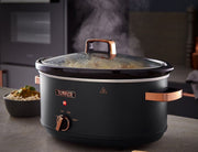 A black and rose gold Tower Cavaletto 6.5L large slow cooker with a glass lid, visible rose gold handles, and a control dial on the front.