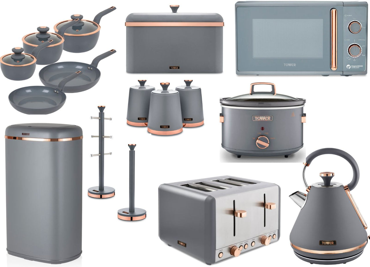 A collection of kitchen appliances and storage items in grey and rose gold, including a kettle, toaster, microwave, slow cooker, canisters, mug tree, towel pole, and sensor bin.