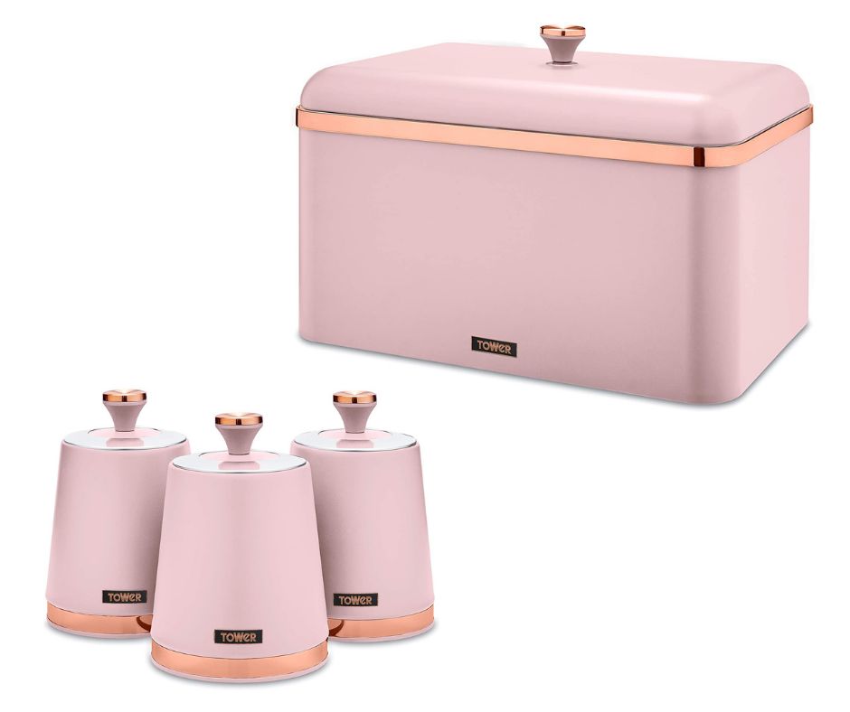 A set of kitchen storage canisters and a bread bin, all in a matte pink finish with rose gold accents.