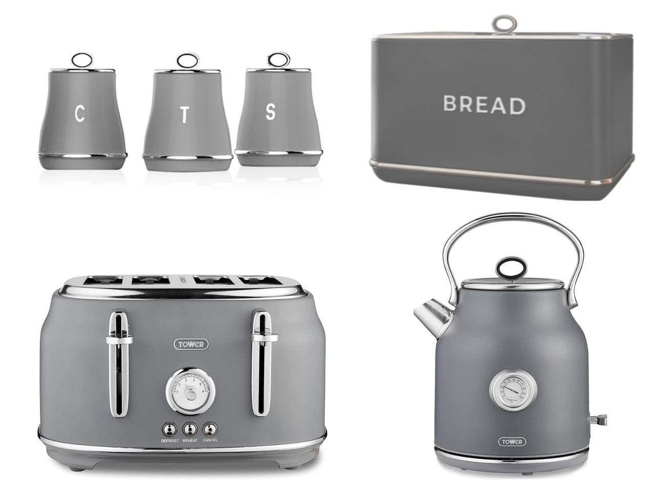 A set of kitchen appliances including a grey kettle, a 4-slice toaster, a bread bin, and three canisters for tea, coffee, and sugar, all matching in grey color with chrome accents.