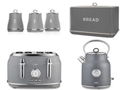 A set of kitchen appliances including a grey kettle, a 4-slice toaster, a bread bin, and three canisters for tea, coffee, and sugar, all matching in grey color with chrome accents.